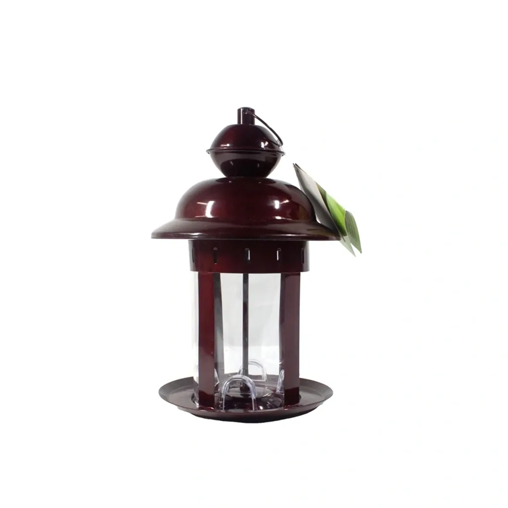 A small dark red lantern with a green hummingbird perched on it.