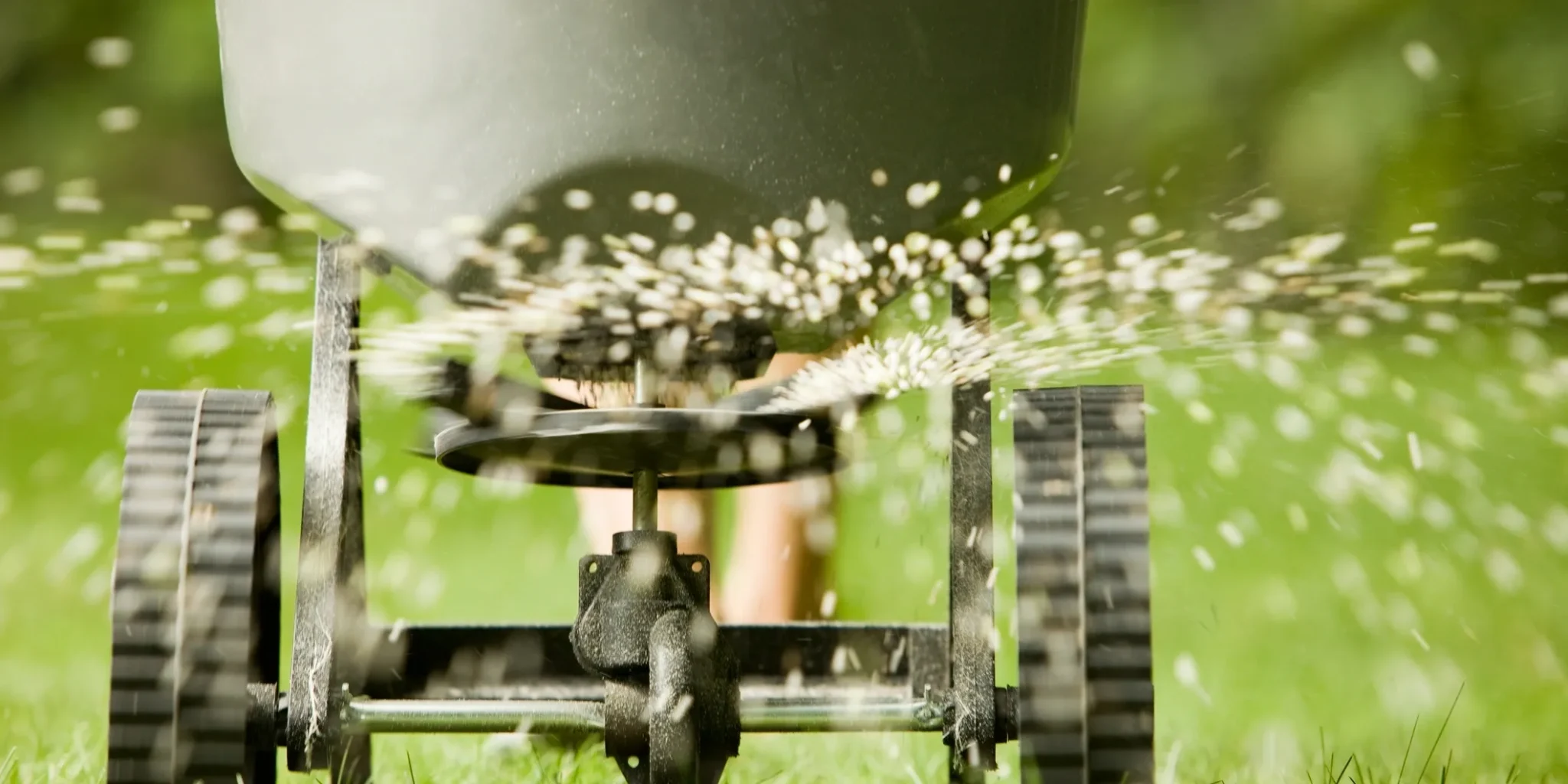 Close-up of a water sprinkler spraying water outdoors.