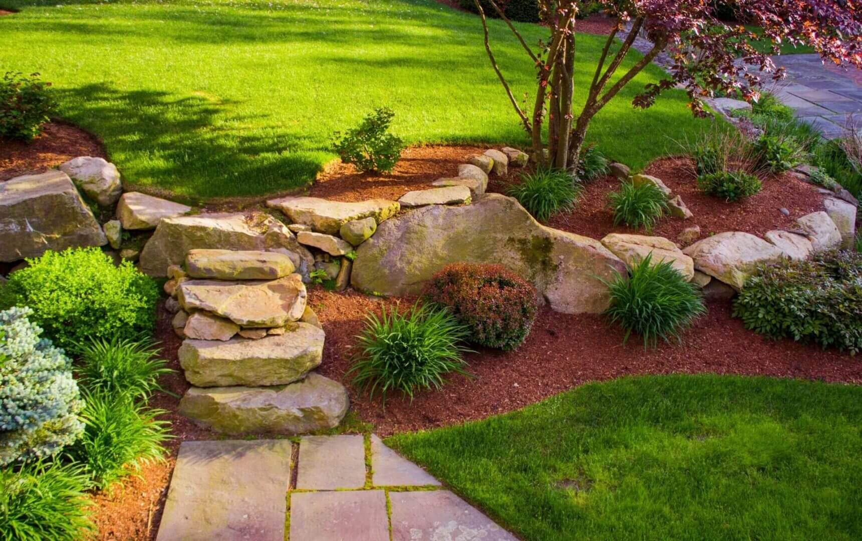 Garden with stone steps and lush greenery.
