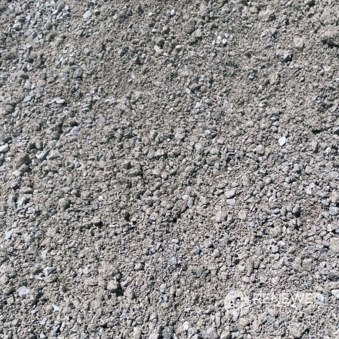 Pile of loose gravel on ground surface.