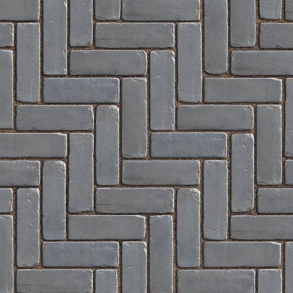 Gray brick herringbone pattern pavement design.