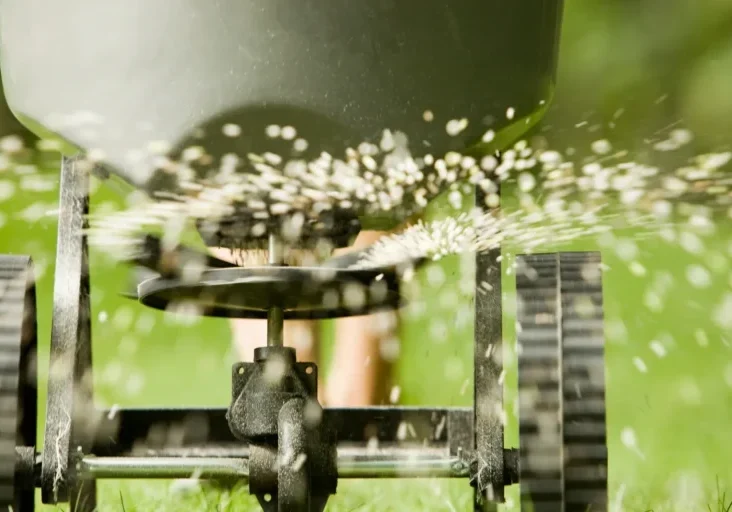 Close-up of a water sprinkler spraying water outdoors.